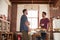 Two male friends hanging out in kitchen, low angle