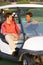 Two Male Golfers Riding In Golf Buggy