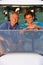 Two Male Golfers Riding In Golf Buggy