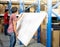 Two male hand holding prepare to assembling woodboard for put on the metal rack  in warehouse or storage and shelves for cardboard