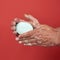 Two male hands in a white soapy foam, body hygiene