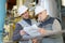 Two male mature engineers looking at paperwork in factory