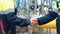 Two male metalworker shaking hands deal partnership at refinery chemical plant outdoor closeup