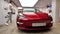 Two male near Tesla Model 3 red sport luxury electric car