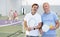 Two male pickleball players standing on indoor court