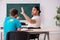 Two male pupils in bullying concept in the classroom