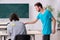 Two male pupils in bullying concept in the classroom