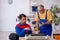 Two male repairmen repairing air-conditioner