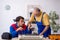 Two male repairmen repairing air-conditioner