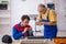 Two male repairmen repairing air-conditioner