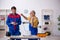 Two male repairmen working at workshop