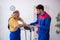 Two male repairmen working at workshop