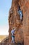 Two male rock climbers go up a canyon wall in New Mexico