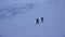 Two male ski mountaineers on a dark foggy morning in the Swiss Alps headed to the Strahlhorn