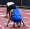 Two male sprinters ready to race in lanes