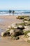 Two Male Surfers Carrying Surfboards Step Into Ocean at Swami`s Beach