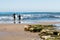 Two Male Surfers Head Out to Sea at Swami`s Beach in Encinitas, California