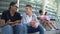 Two male teenagers laughing at female classmates sitting beside, youth gossips