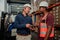 Two male workers receiving emails on digital tablet while standing warehouse