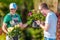 Two Man Choosing Plants For Landscaping Job