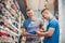 Two man deciding on new sports shoes in store