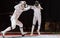 Two man fencing athletes fight