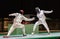 Two man fencing athletes fight