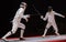 Two man fencing athletes fight