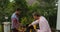 Two Man Putting Food On Barbecue Young Friends Group Gathering On Summer Terrace Having Party Cheerful Dancing