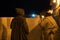 Two Man in Traditional moroccan djellaba walking on the street of Asilah Medina, on Atlantic Coast in Morocco. Caucasian