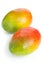 Two mangoes over white background