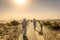 Two mans dressing with arab white clothes in a hotel in Oman. Orange predominance in the picture, feeling of desert, dry place, no