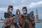 Two masked women in costume with decorated fans, at San Giorgio, with St Marks Square and bell tower behind