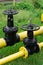 Two massive black valves on a yellow gas pipe