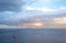 Two mast sailing boat in the far distance off the Bay of Naples near Sorrento in Italy. Photographed with moody sky in the early m