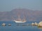 Two-masted schooner sails along the coast