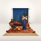 Two mates, men recreating camping activity over grey background with nature wallpaper. Sleeping bag, guitar