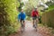 Two Mature Male Cyclists Riding Bikes Along Path