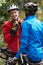 Two Mature Male Cyclists Riding Bikes Along Path