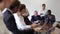 Two mature male executive board members dressed in formal suits holding corporate team meeting in conference hall