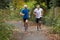 Two Mature Male Joggers Running Along Path