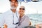 Two mature people standing on sailboat