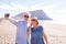 Two mature people taking a selfie on the beach smiling and having fun and enjoying - senior or pensioners enjoying their vacations