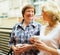 Two mature women drinking coffee