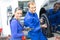 Two mechanics changing a wheel on a car