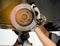 Two mechanics work together to fix the car\'s suspension and disc brakes.