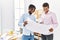 Two men architect workers smiling confident holding blueprint standing at architecture studio