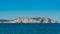 Two men in a boat head to lighthouse in Ibiza. sunny Conejera islands, St Antoni de Portmany Balearic Islands, Spain