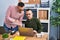 Two men business workers using laptop writing on paperwork at office