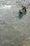 Two men in a canoe navigating wild river rapids